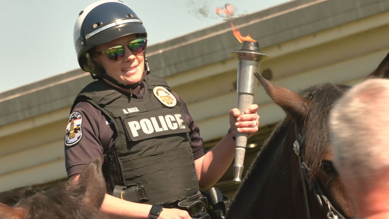 Law enforcement officials carry Torch of Hope through Louisville for Special Olympics Kentucky